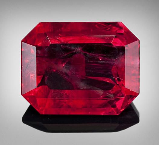 Octagon shape red and black red beryl gem with black stand