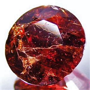 Ruby-red and pale brownish painite stone