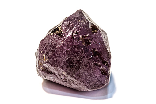 Shiny rock formed alexandrite that has a granite texture