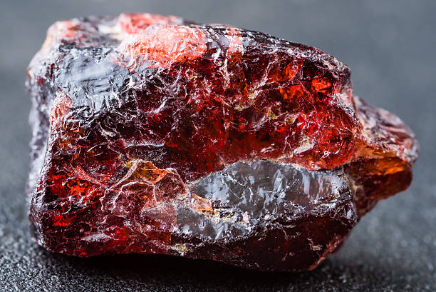 A Piece Of Unpolished Red Garnet Stone On The Ground