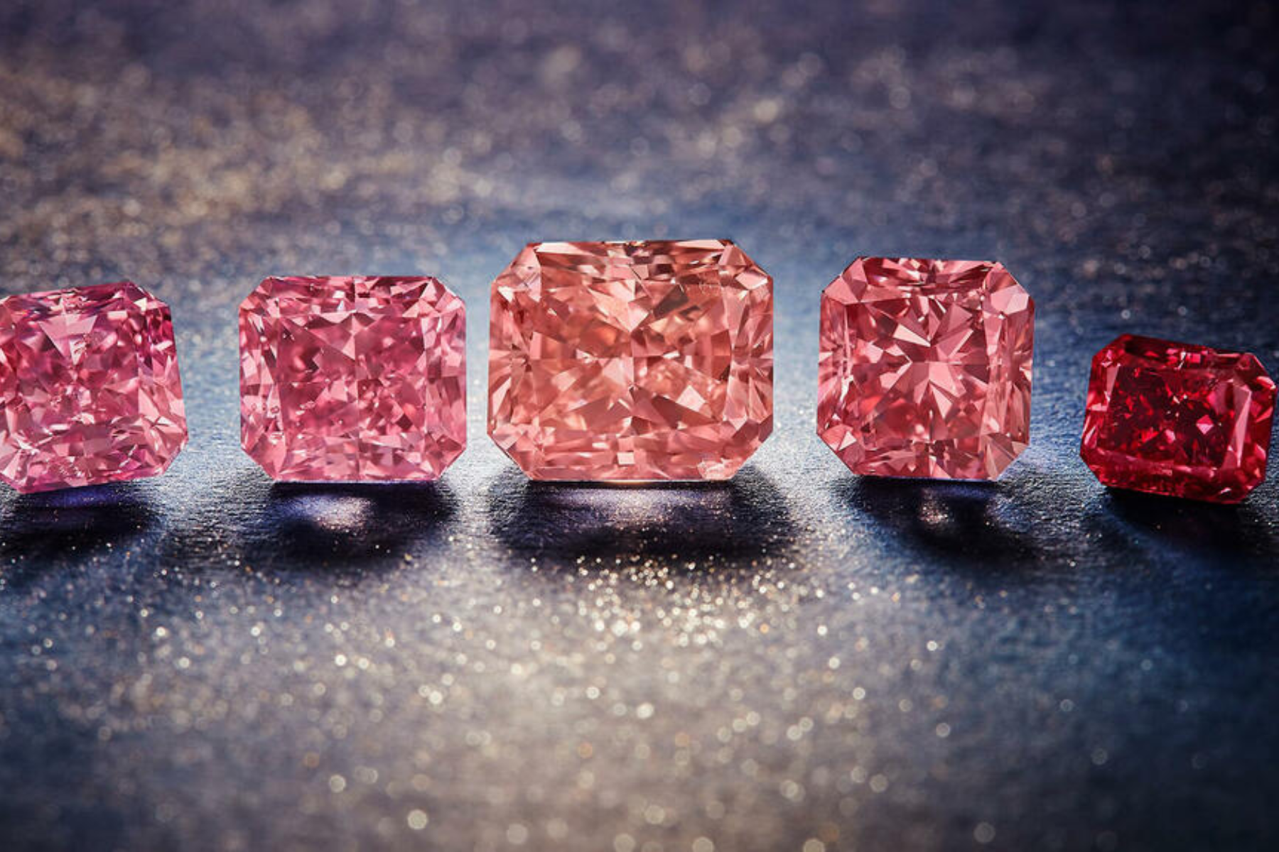 Five different sizes and shapes of argyle pink diamonds