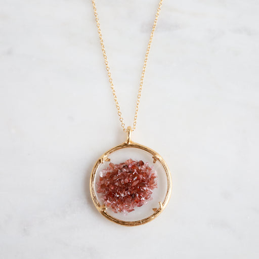 Catherine Weitzman Birthstone pendant with round gold body and has a crystal inside