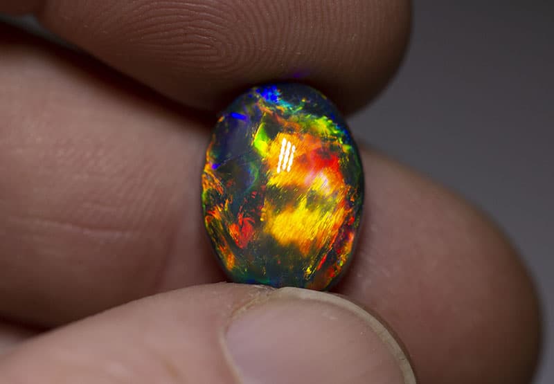 Black Opal - Luminous Colored Gemstone Through The Dark