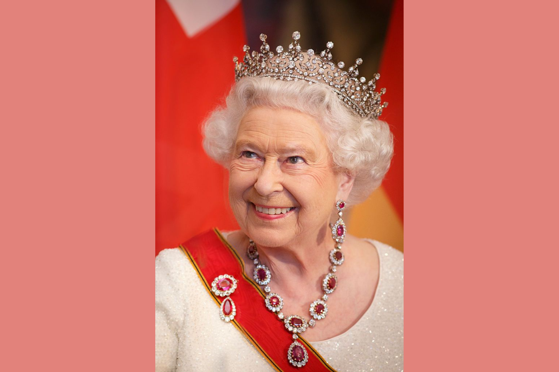 Queen Elizabeth II smiled while wearing her Crown Ruby Necklace and Crown Ruby Brooch