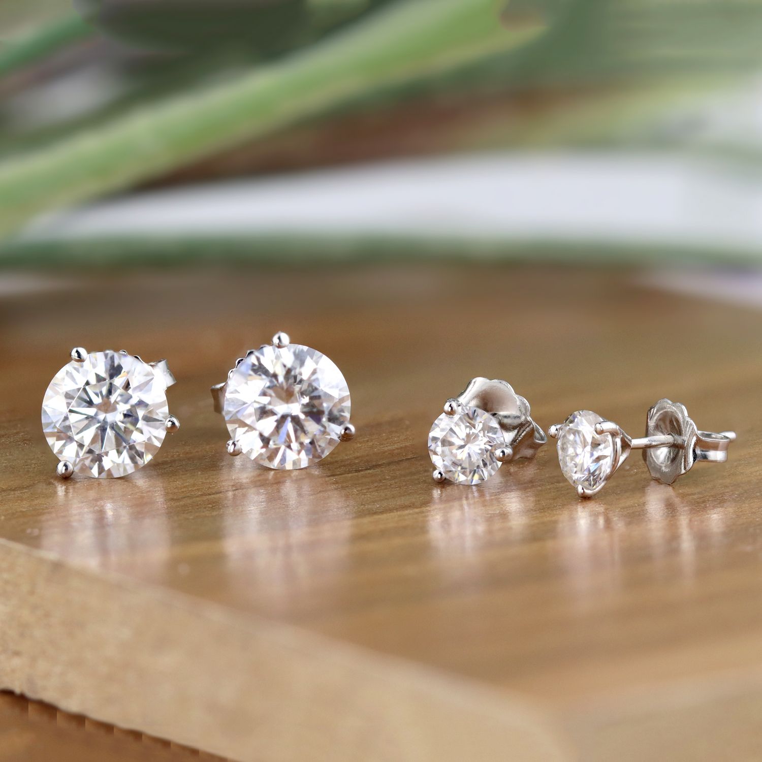 Pieces of Diamond Studs Earrings on a wooden table