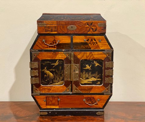 A beautiful and antique chinese wooden jewelry box on a wooden table