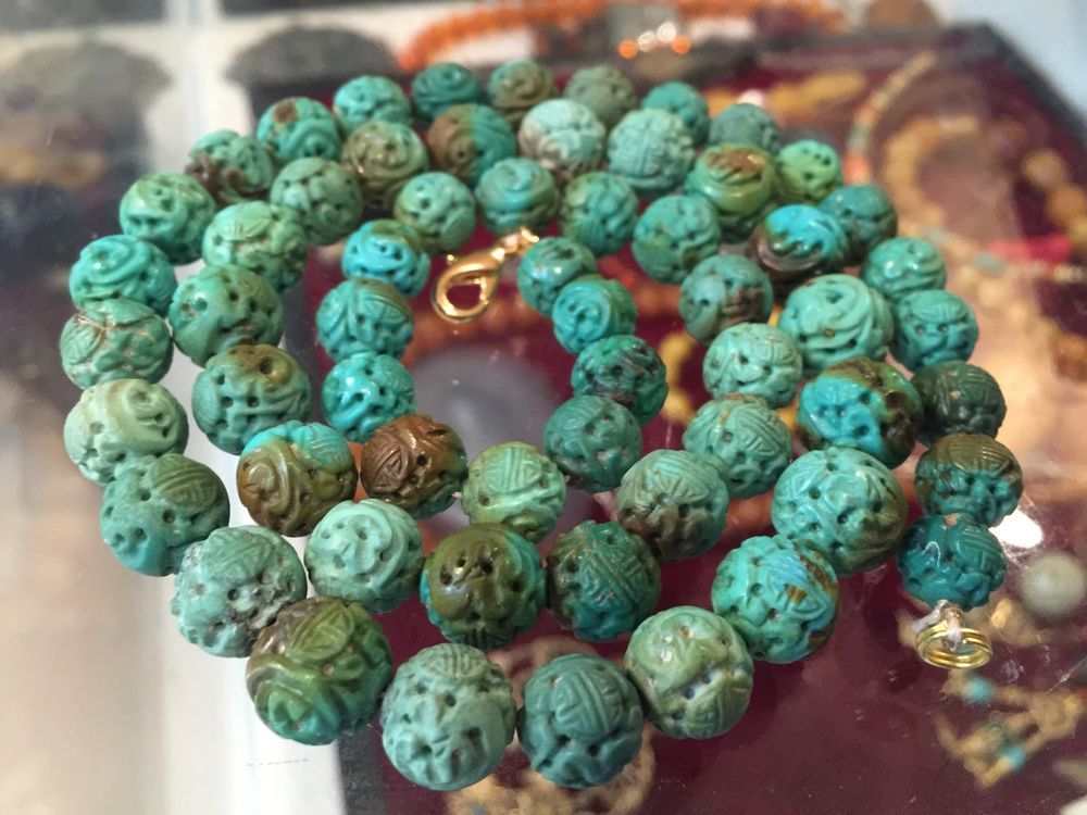 Antique turquoise beads under the glass