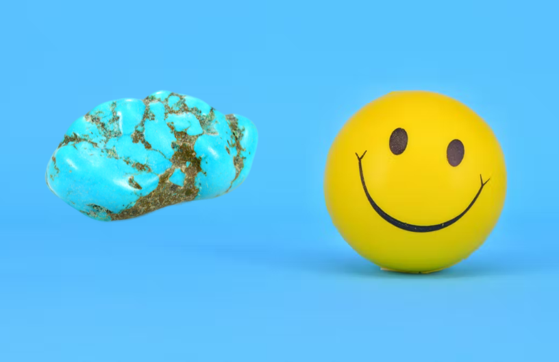 A turquoise stone and a smiley face in yellow