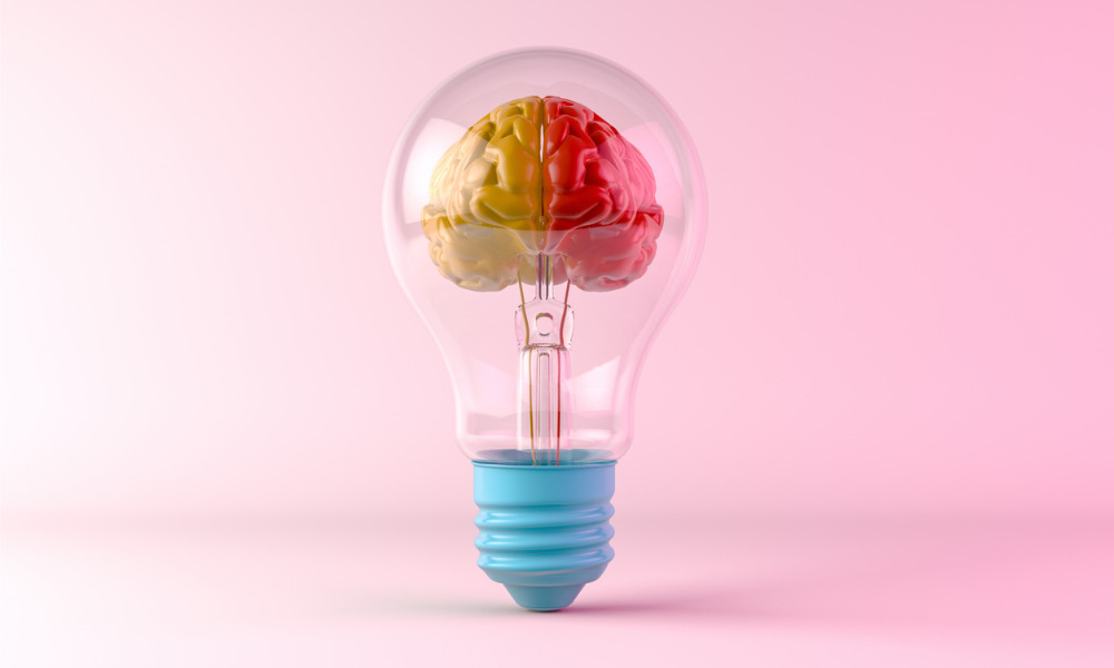 A light bulb witrh a left yellow and right red part of brain inside