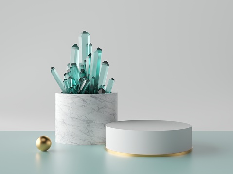 Aquamarines on a cylinder, a white and gold circle beside it, and a golden sphere on a table