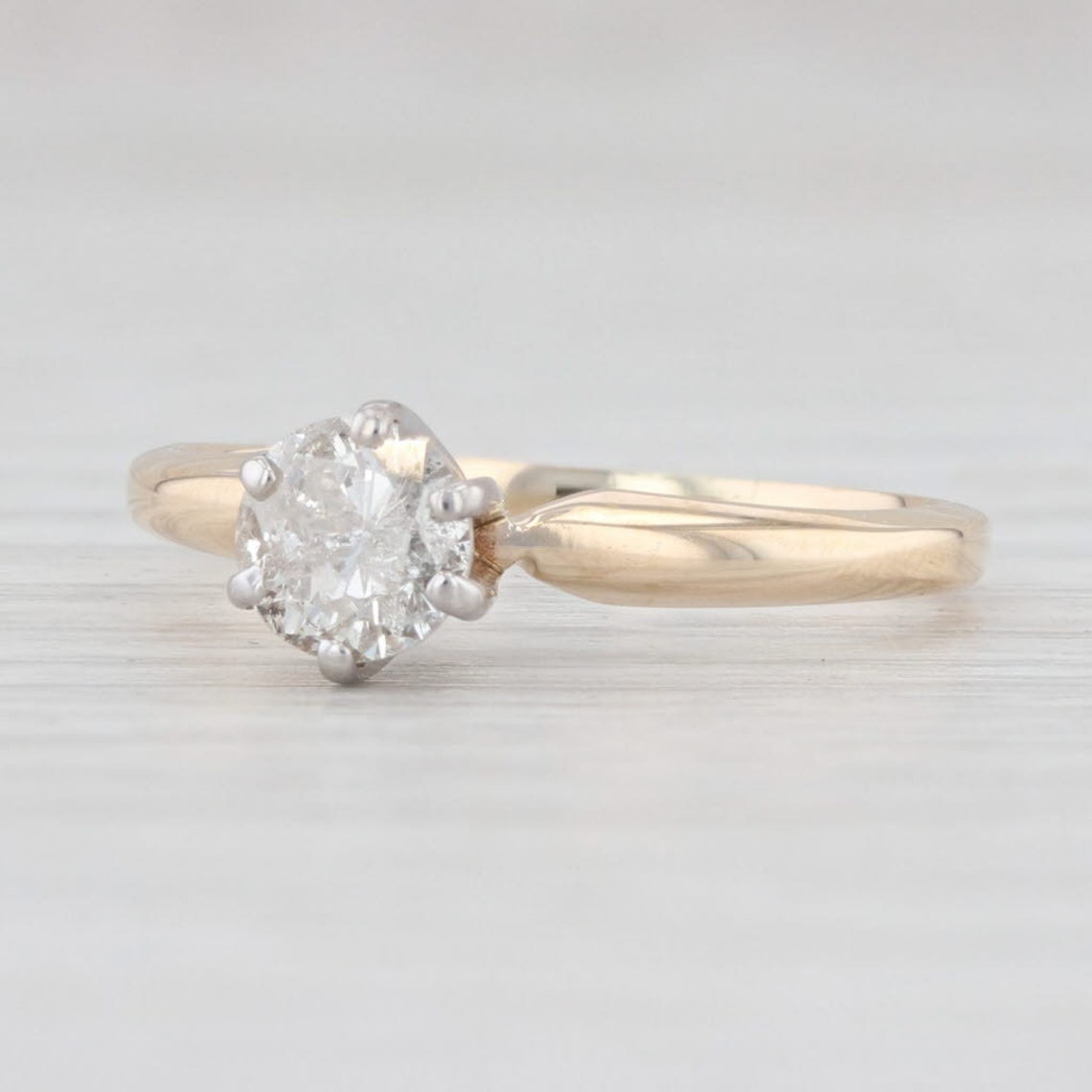 A 14K white and yellow gold ring with a stunning diamond gem