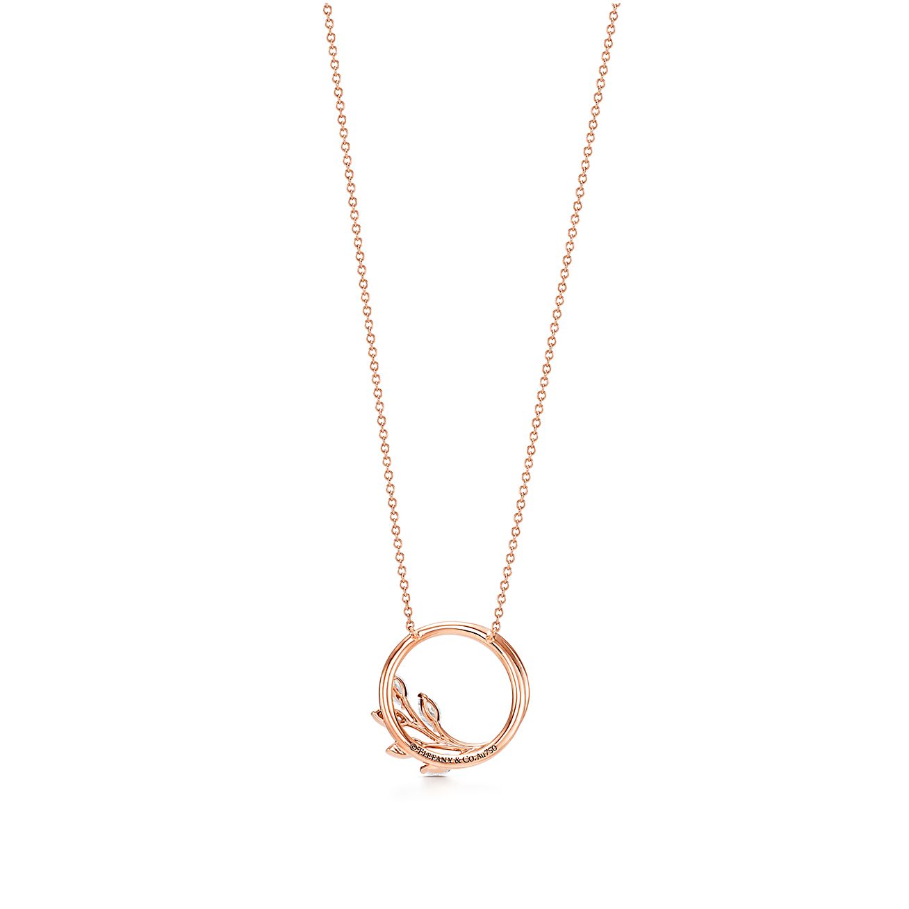 A rose gold necklace with a chain and has a leaves like design in the circles