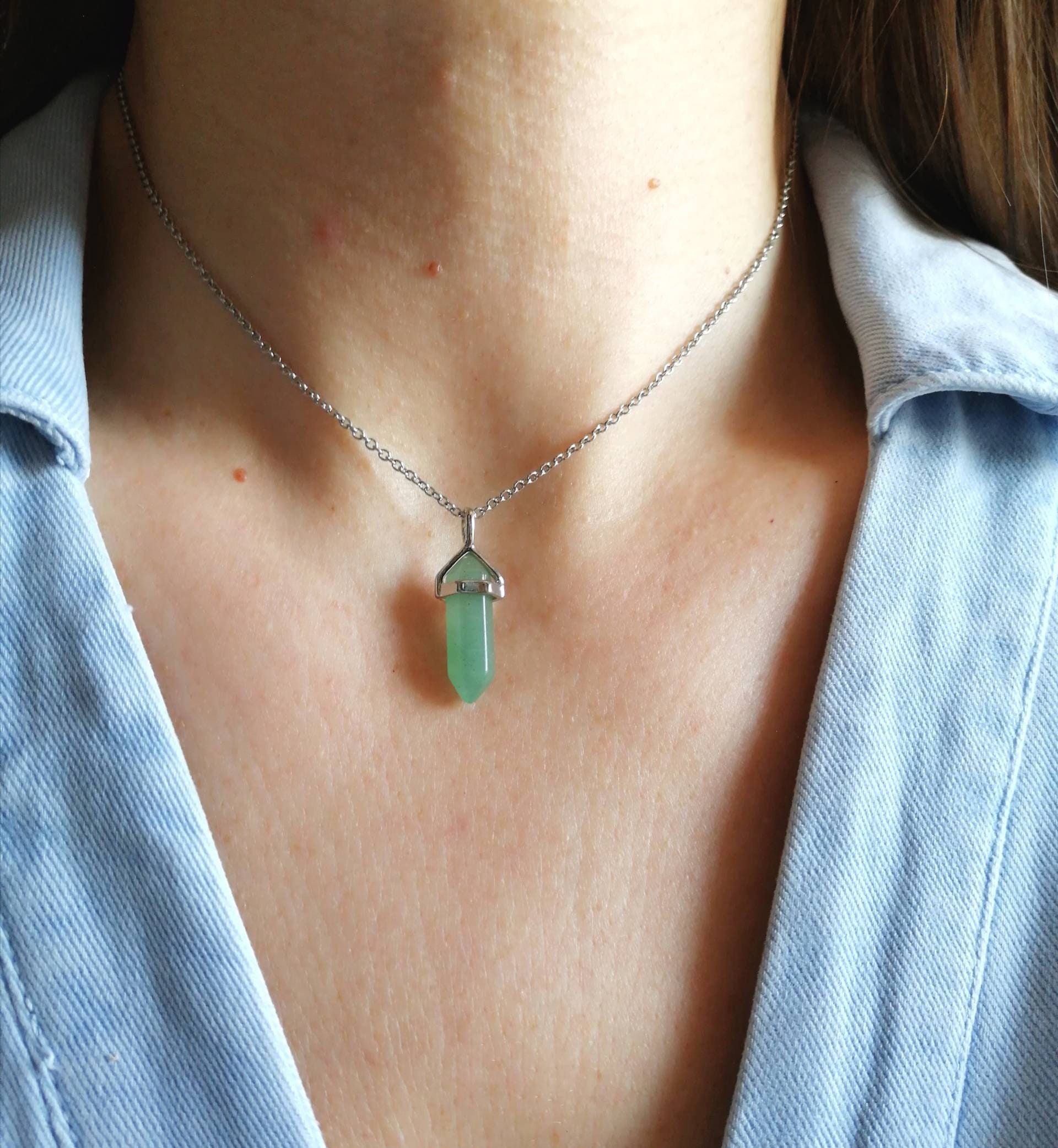 A woman wearing a Green Aventurine necklace