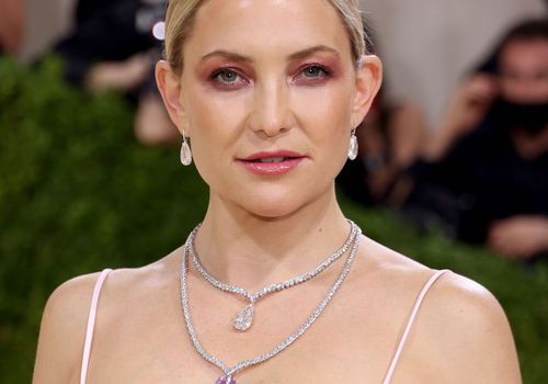 Kate Hudson attends an event while wearing a charm stone necklace