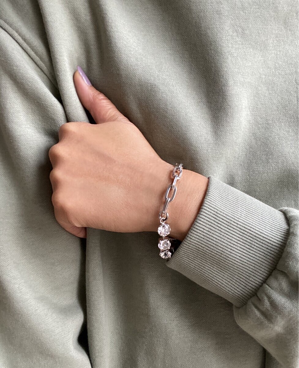 A woman wearing a silver bracelet with crystal