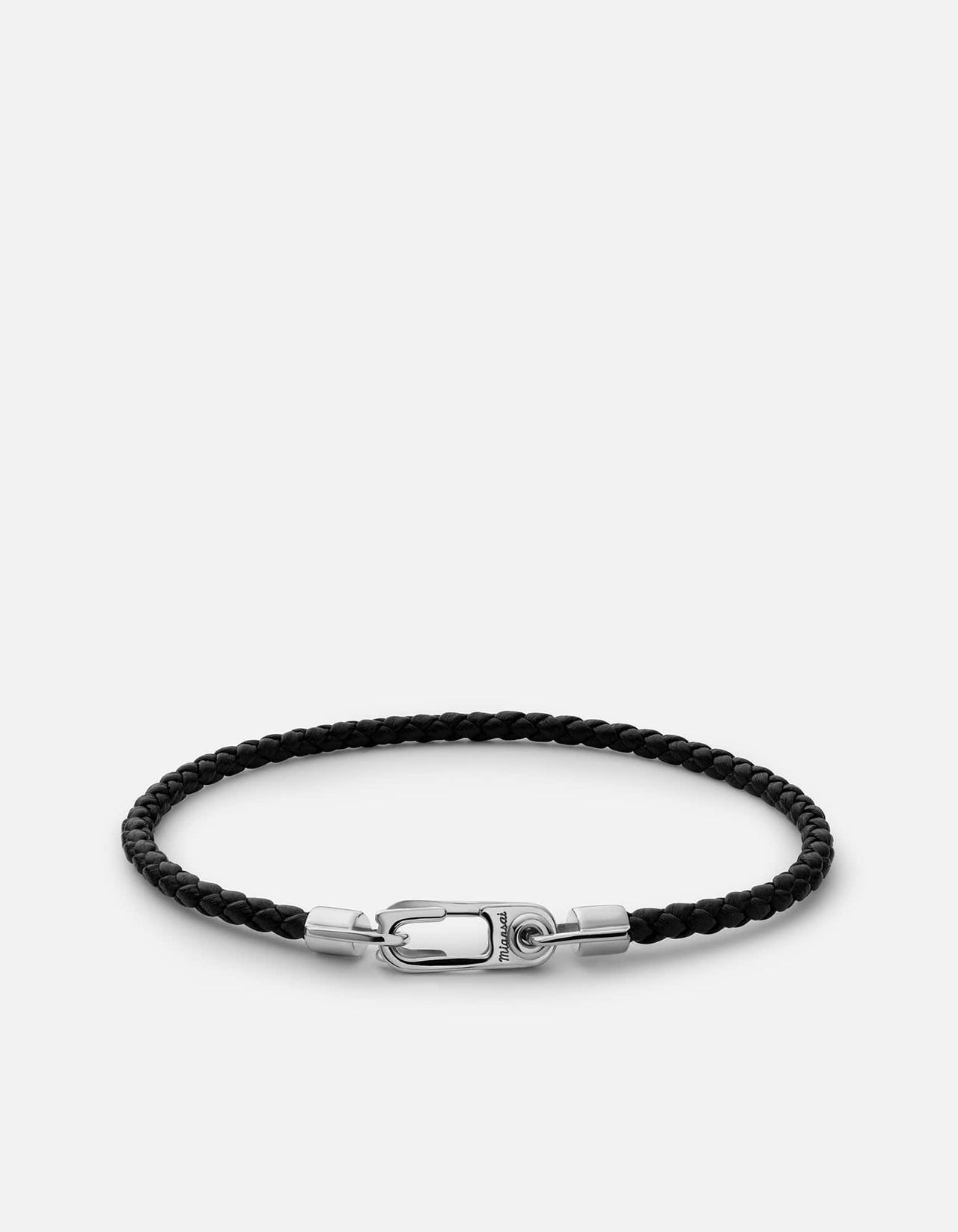 The Annex Leather Bracelet, Sterling Silver is placed in a white surface and has a unique lock feature