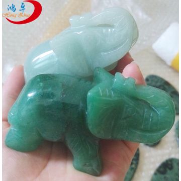 Aventurine gemstones carved into miniature elephants in the palm of the hand