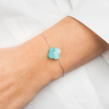 A woman's wrist is adorned with an Amazonite clover bracelet
