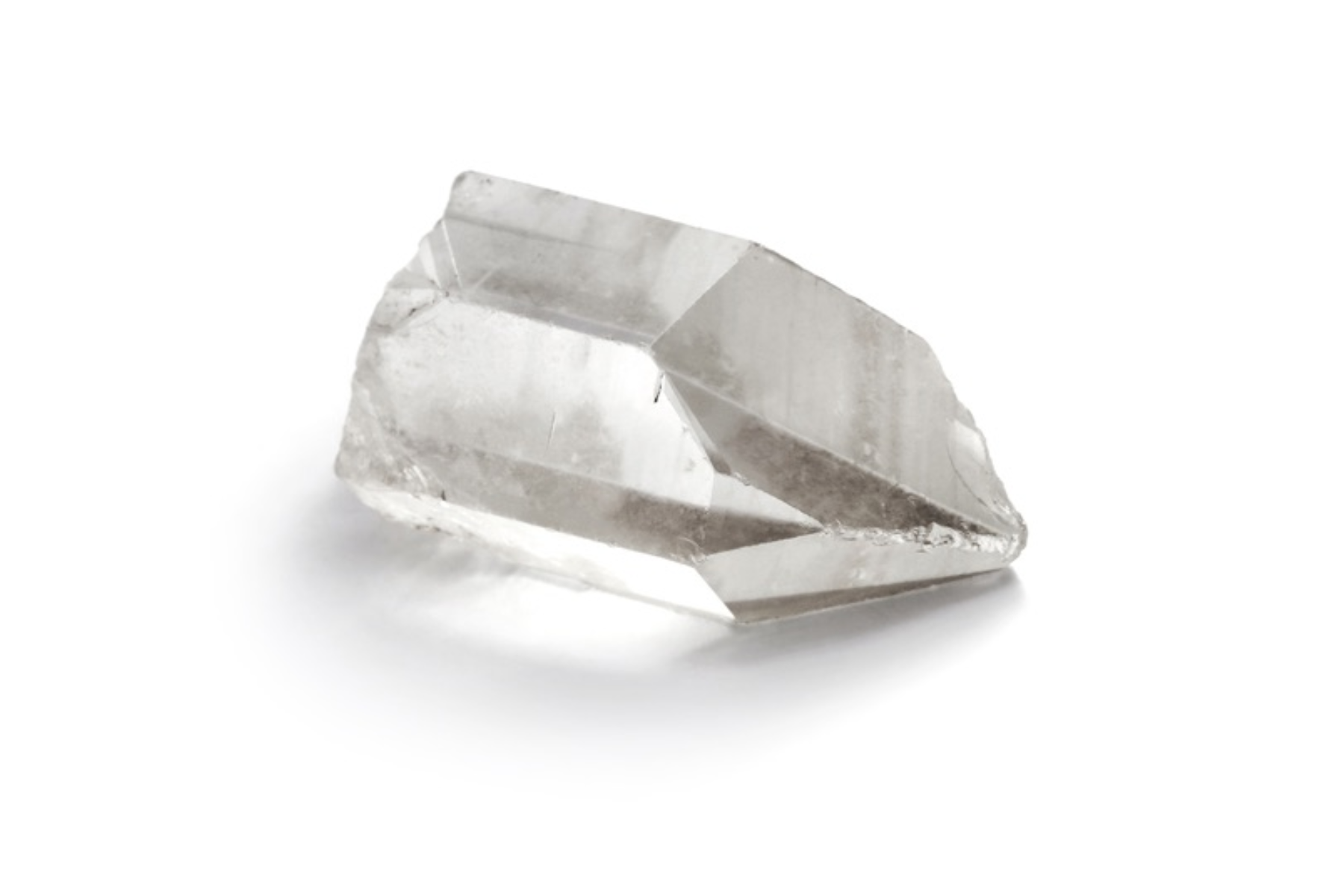 A pointed clear quartz crystal that is transparent and clear