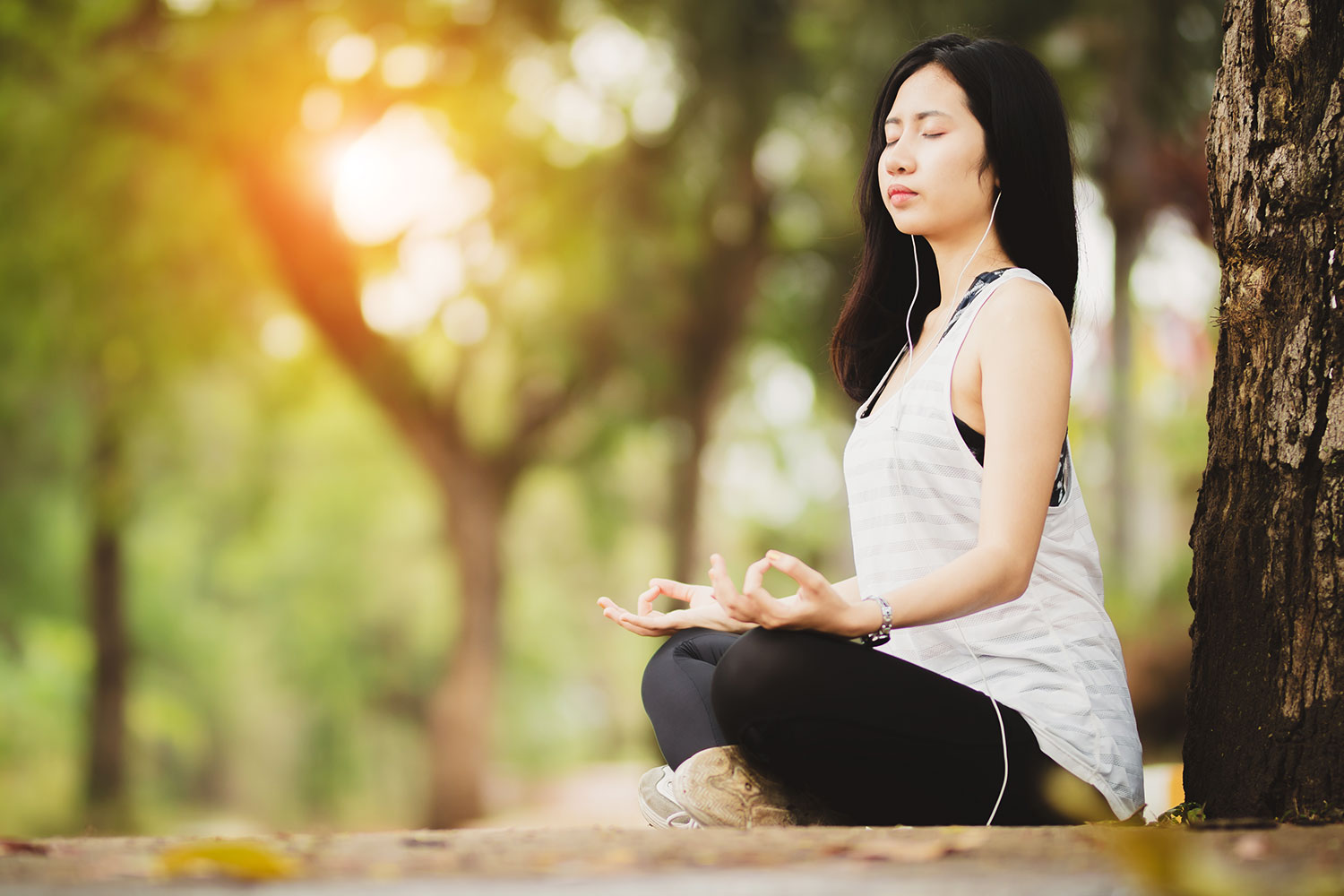 A woman with her earphones while meditating