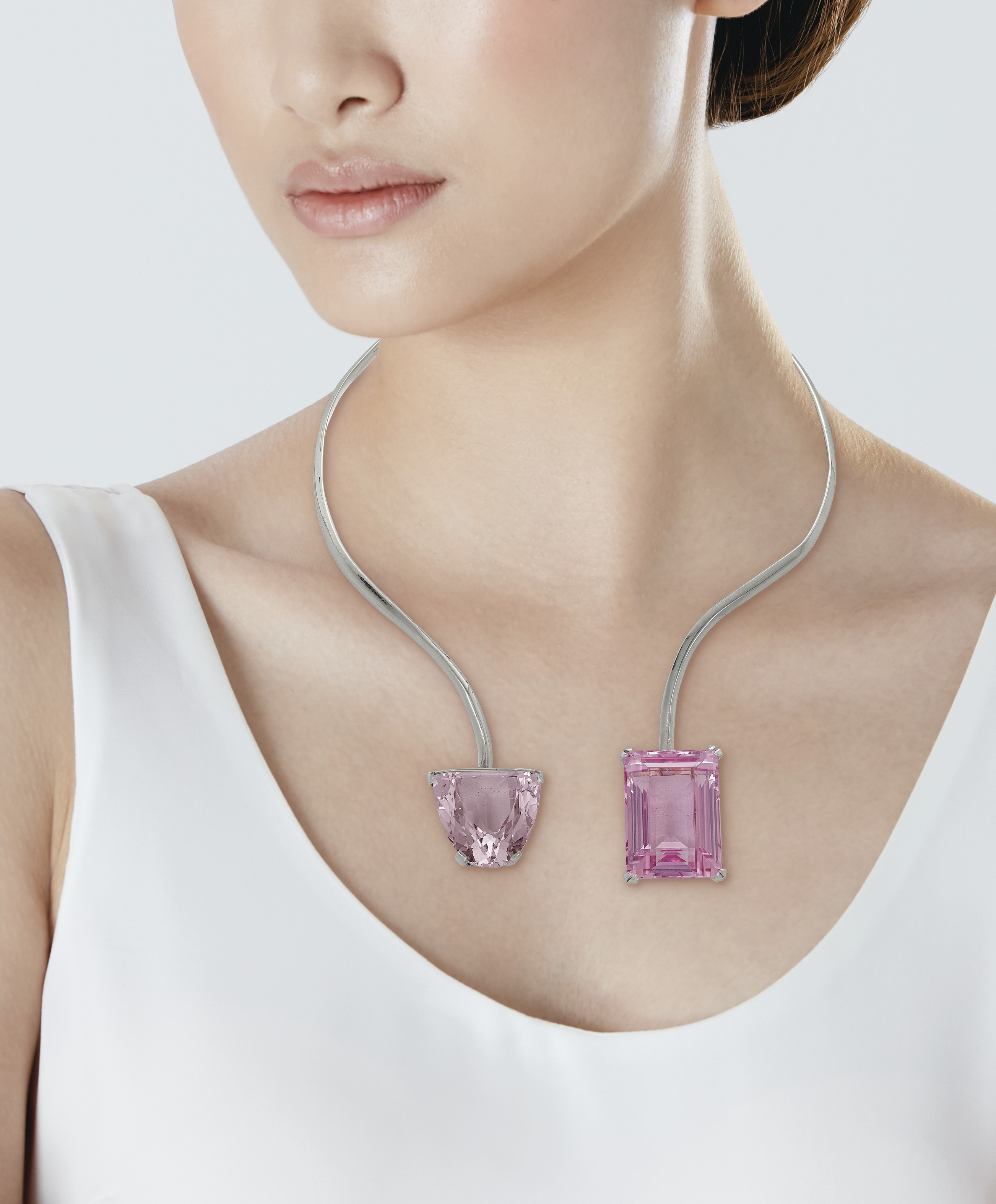 A woman wearing a necklace with two Kunzite pendants