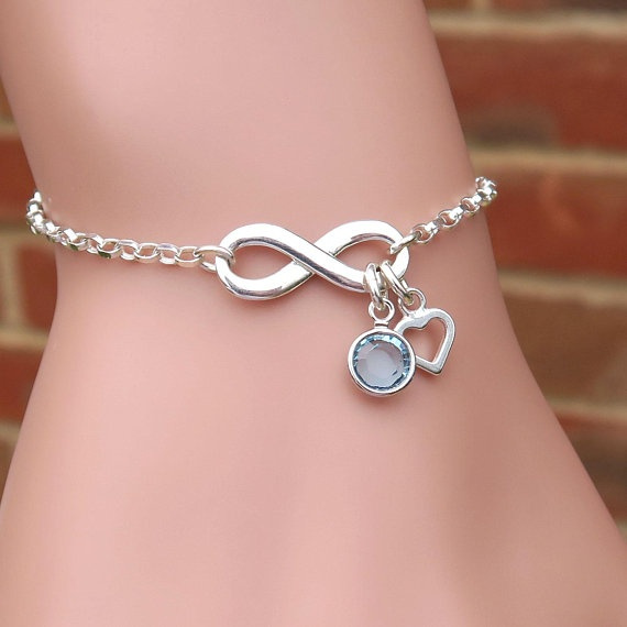 A woman wearing a silver infinity bracelet