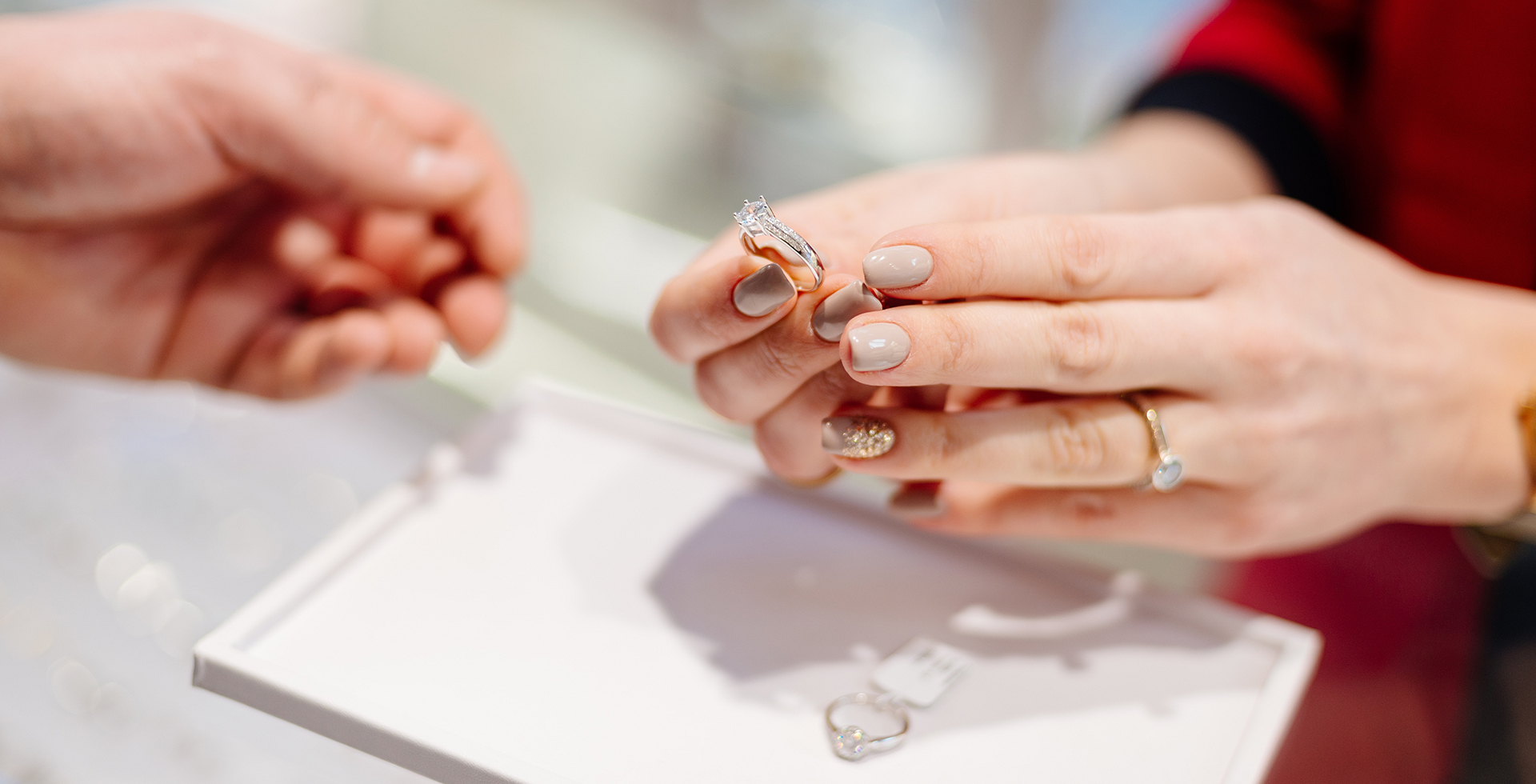 A woman showcases a diamond ring in a jewelry store