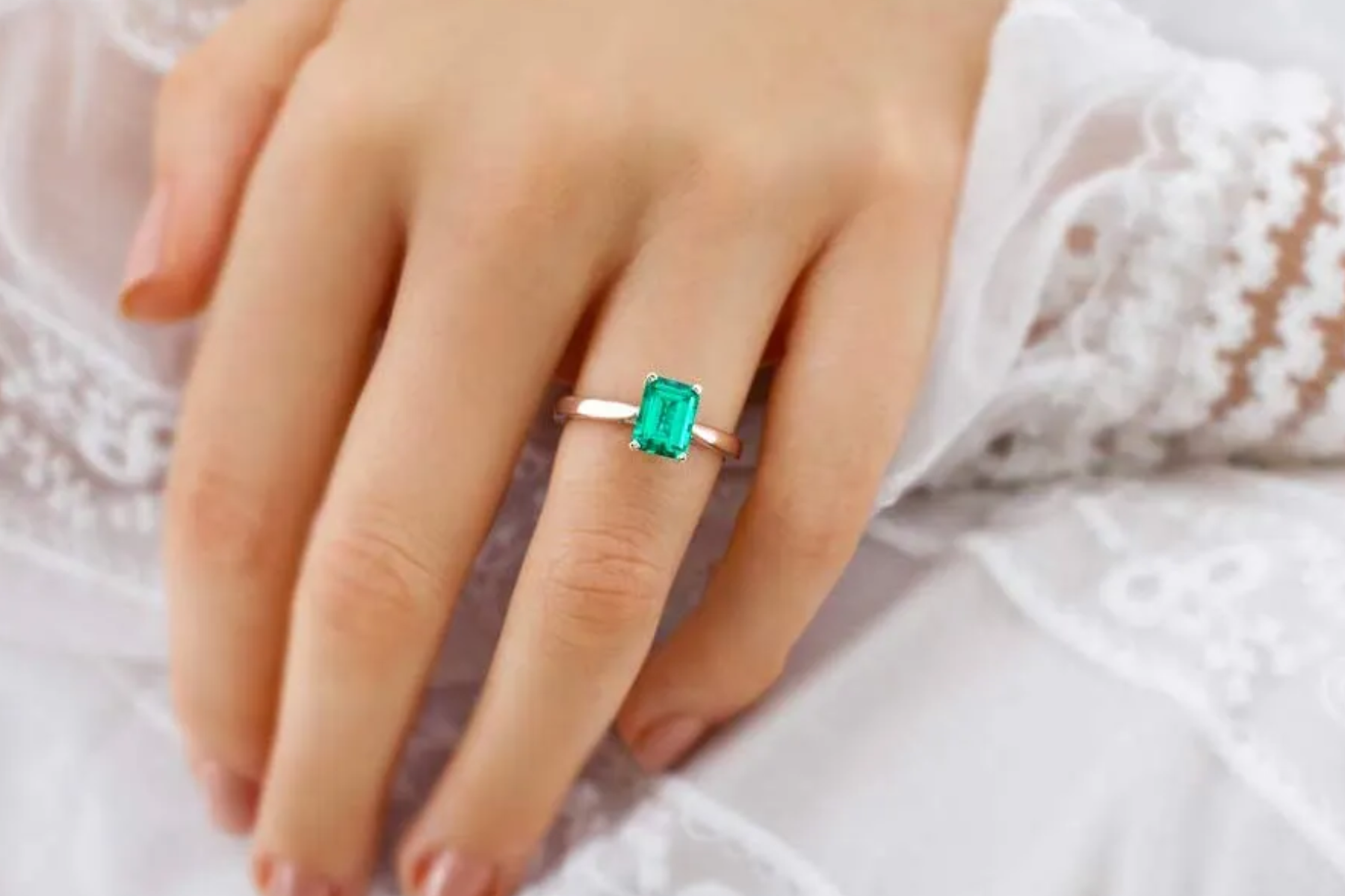 Emerald ring on woman's finger