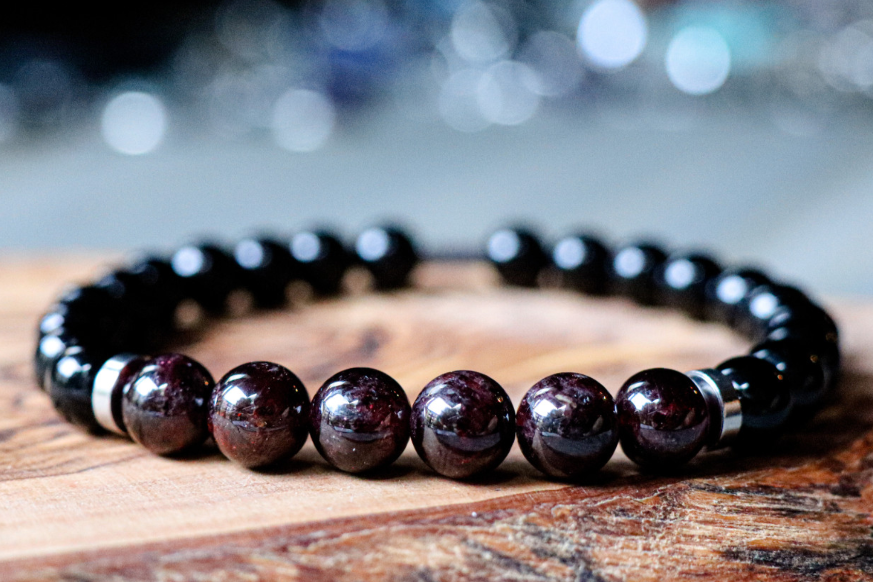 A wooden table with an onyx bracelet