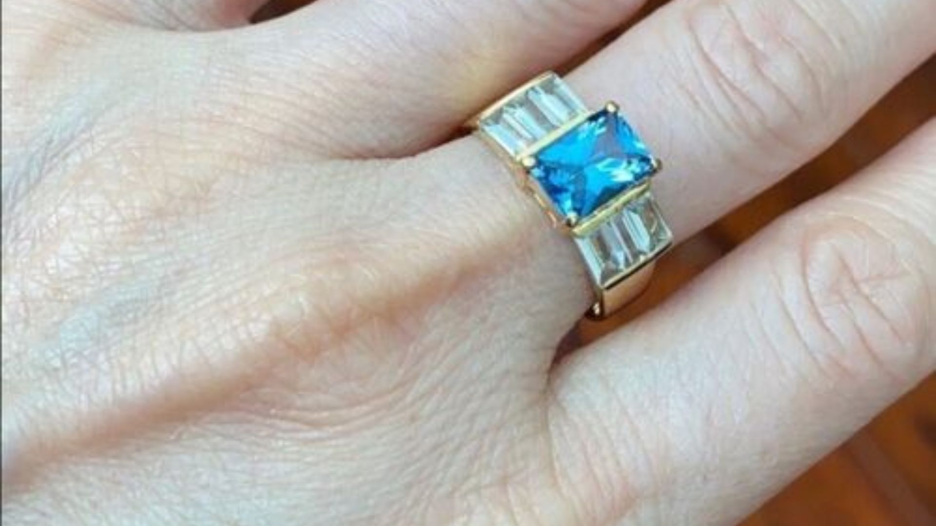 Person Wearing A Ring With Aquamarine Gemstone