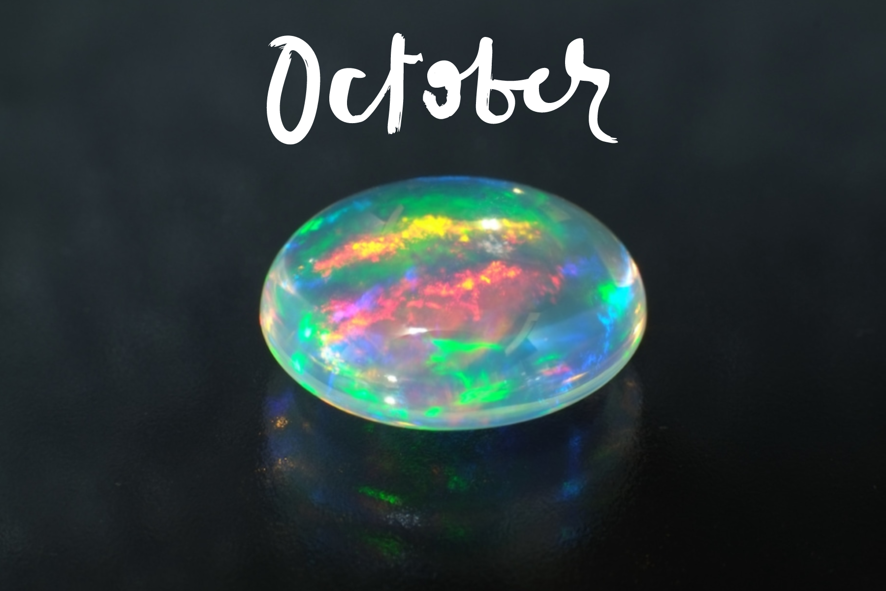 A word "October" and an oblong opal stone