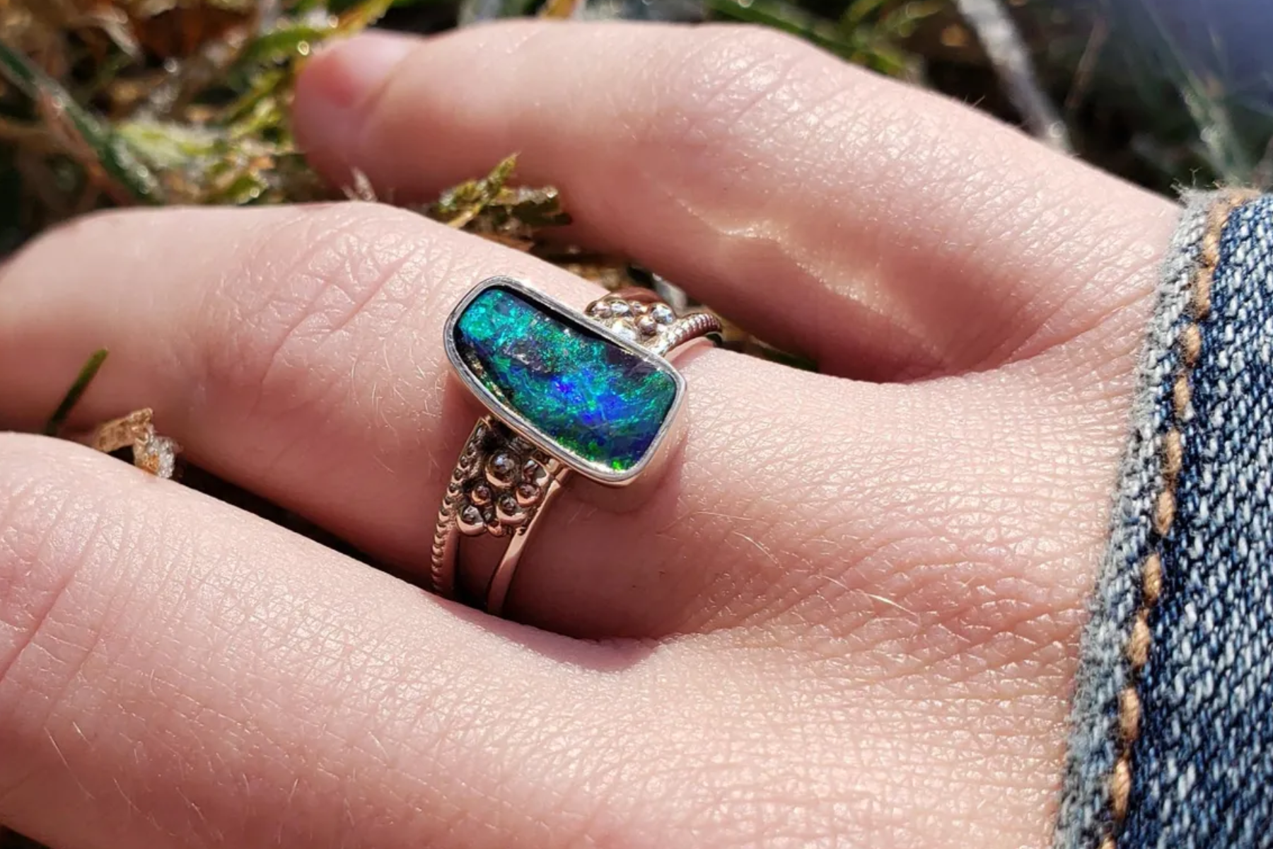 Opal ring on woman's finger