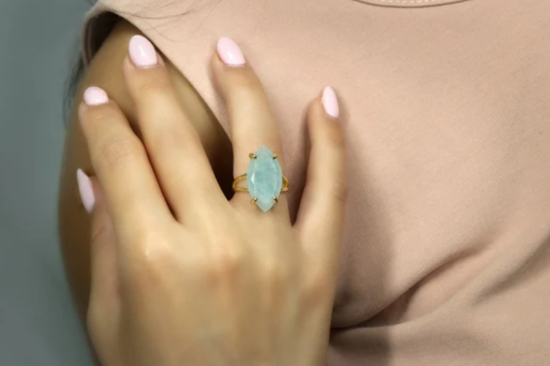 A lady with an aquamarine ring