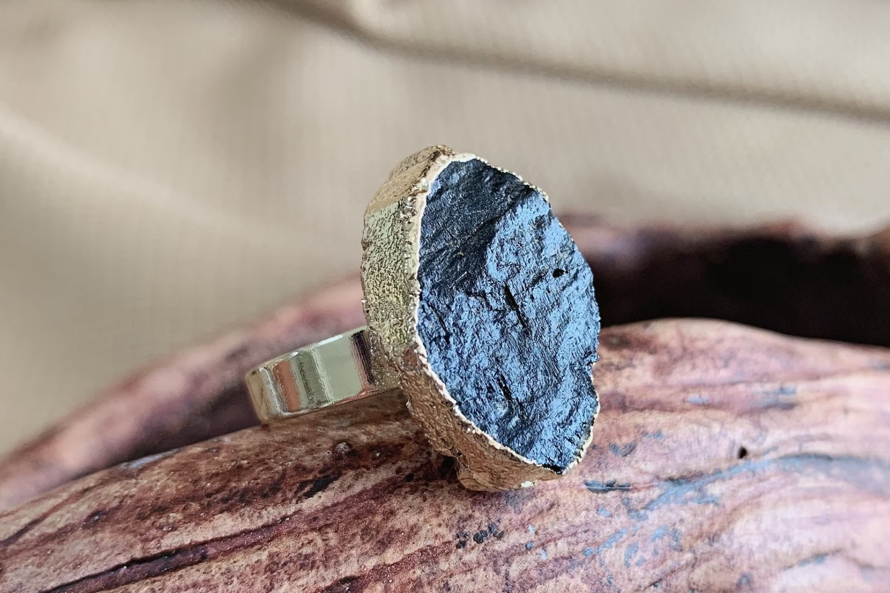Raw obsidian ring on a ring