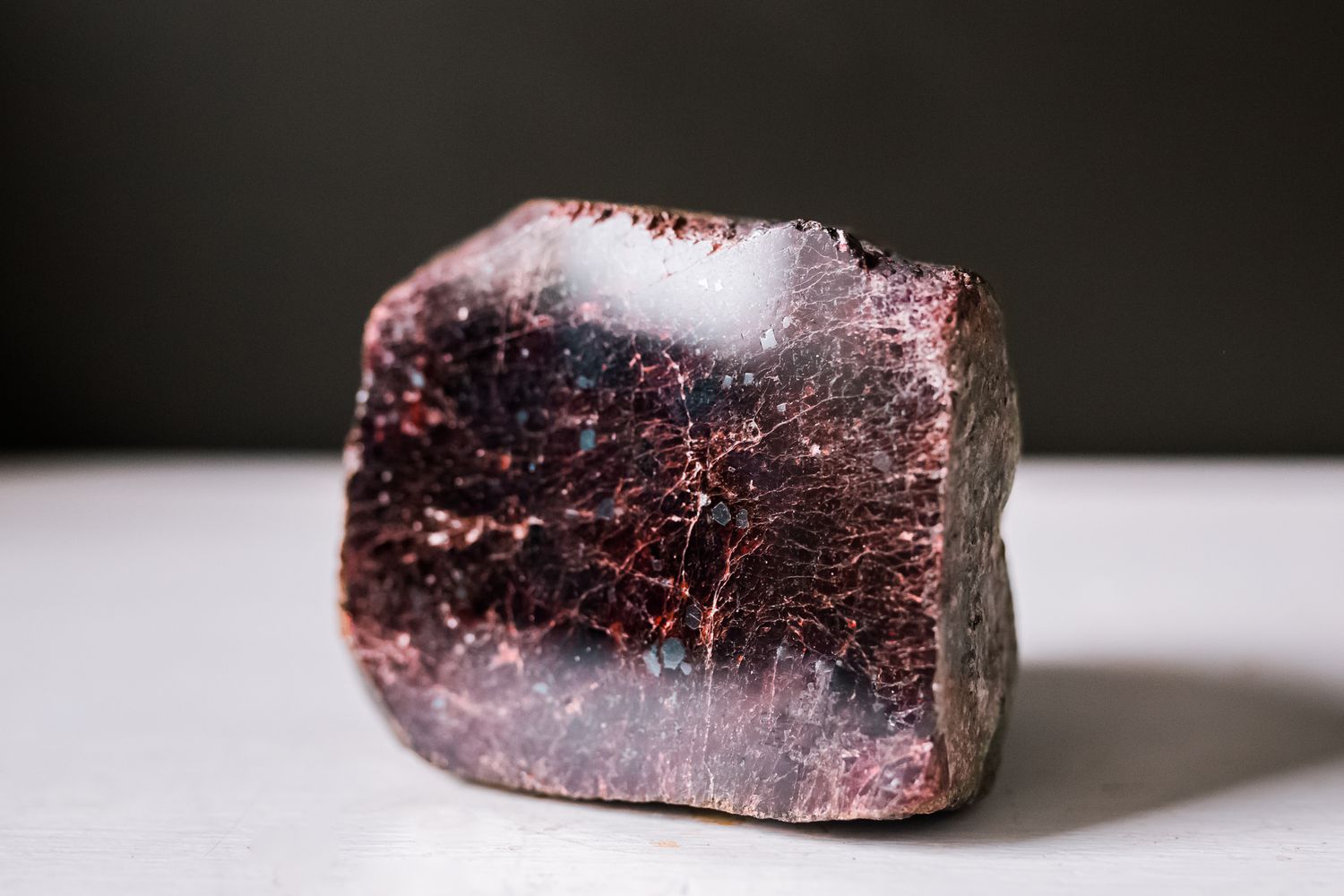 A Garnet gemstone placed on a white table
