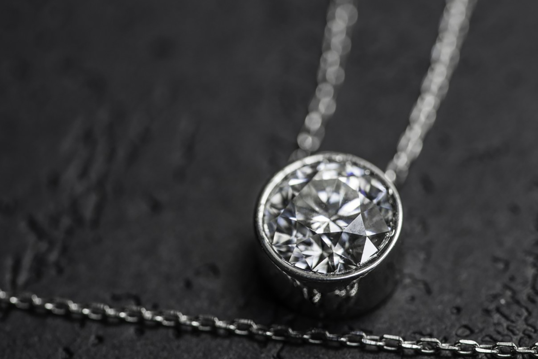 A necklace with a round diamond pendant