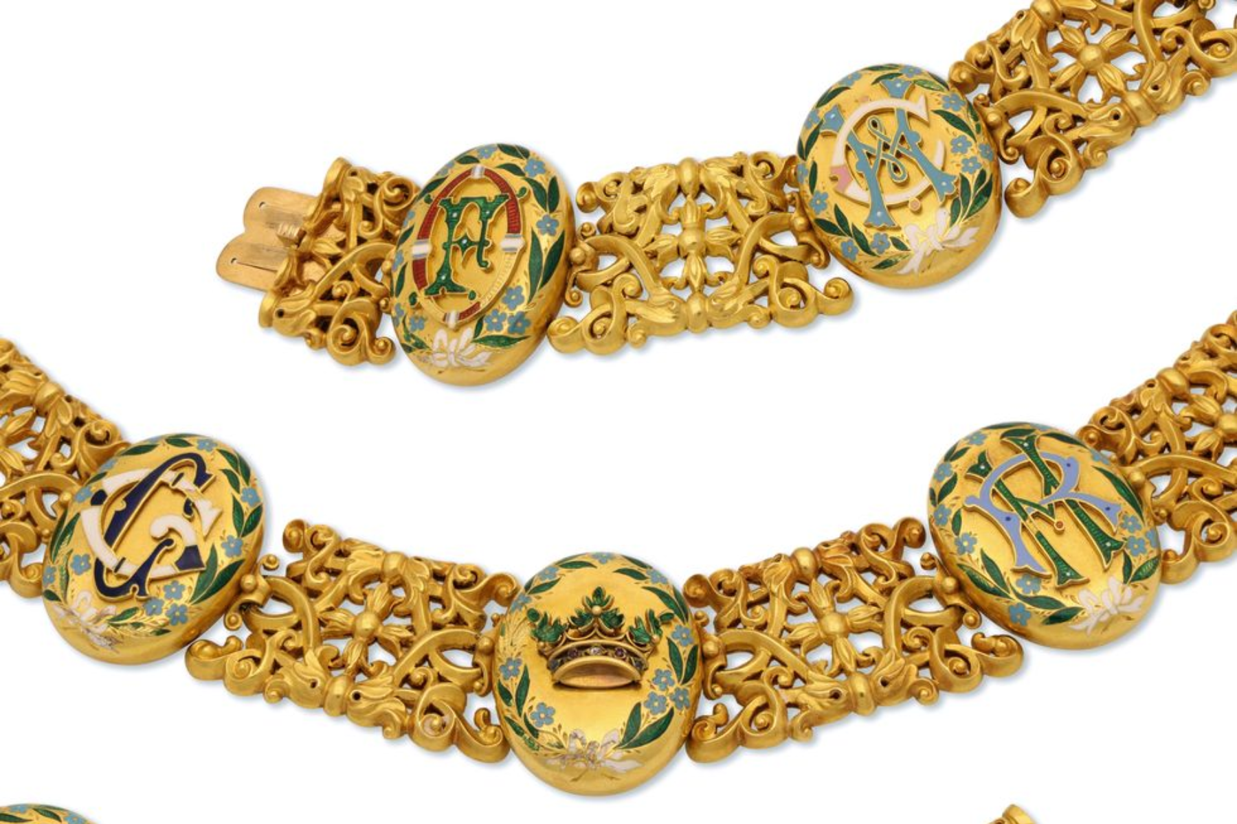 The necklace’s gold collar set design is broken up by eight oval glazed back lockets, seven of which consist of engravings of their children’s initials at the front