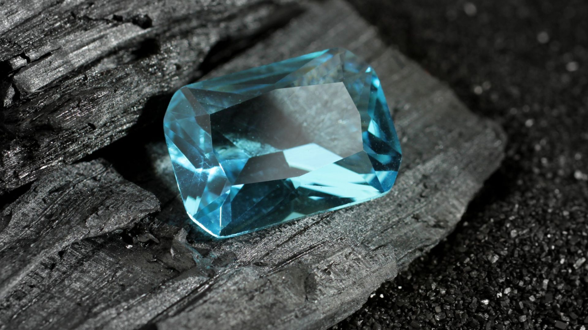 Blue Gemstone On Black Coal Stone