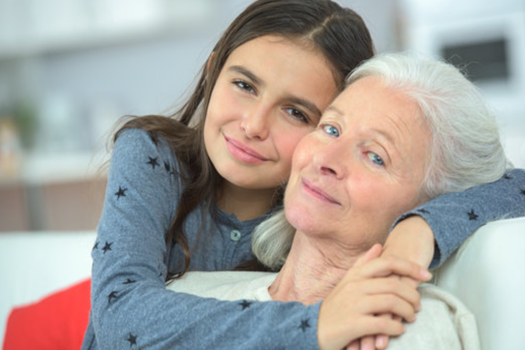 A grandson embraces his grandmother