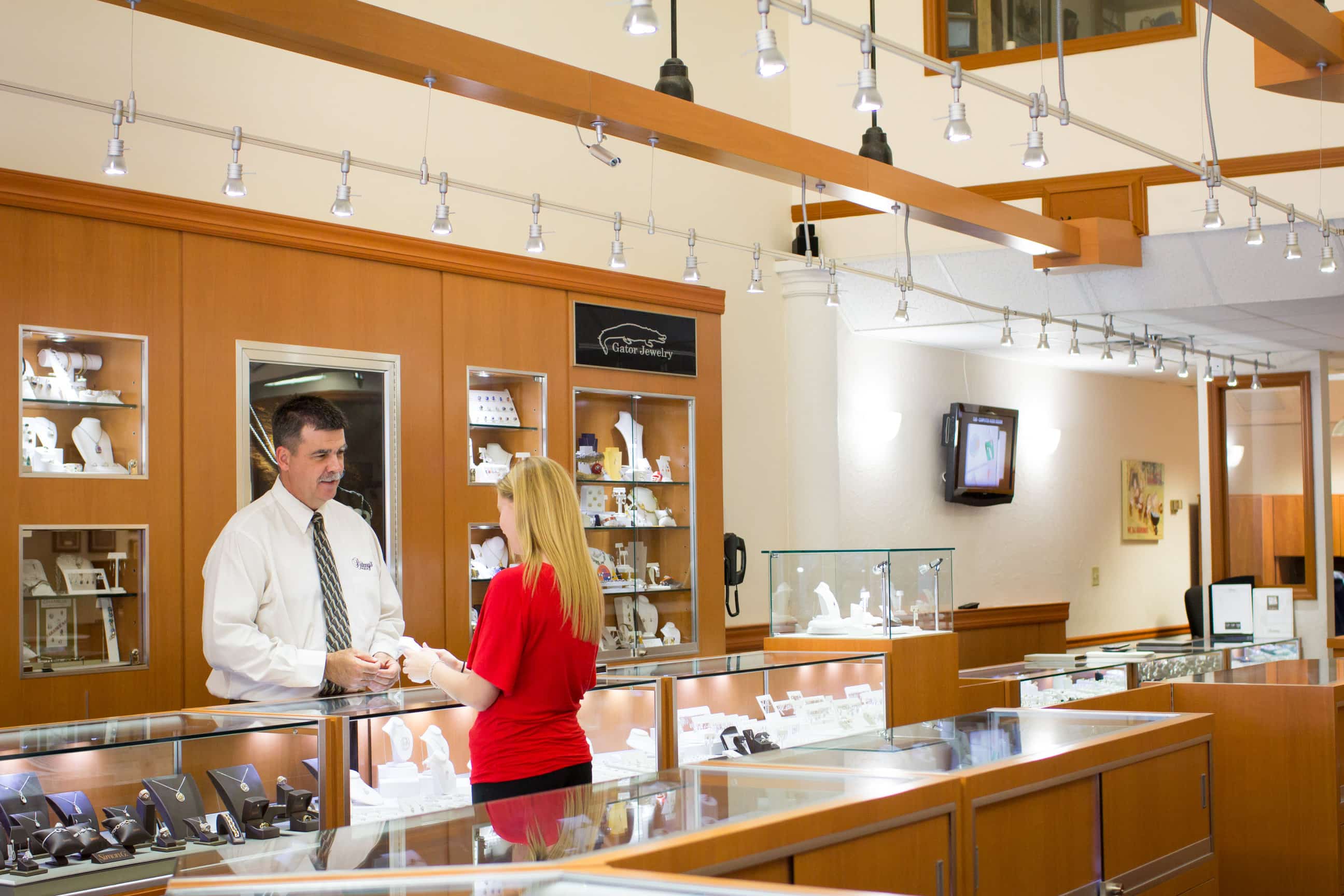 A local jewelry shop with the owner and a client at the counter