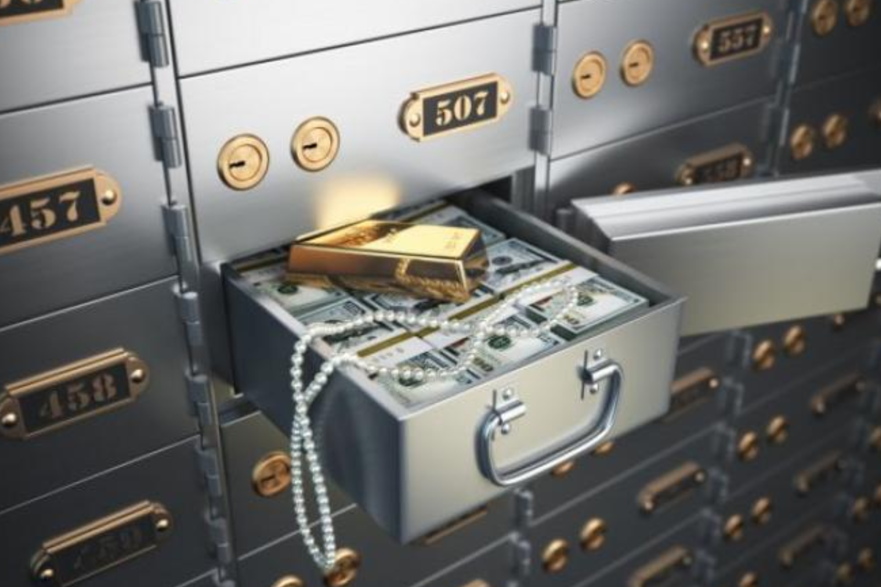 A deposit box containing cash, a pearl necklace, and a gold bar