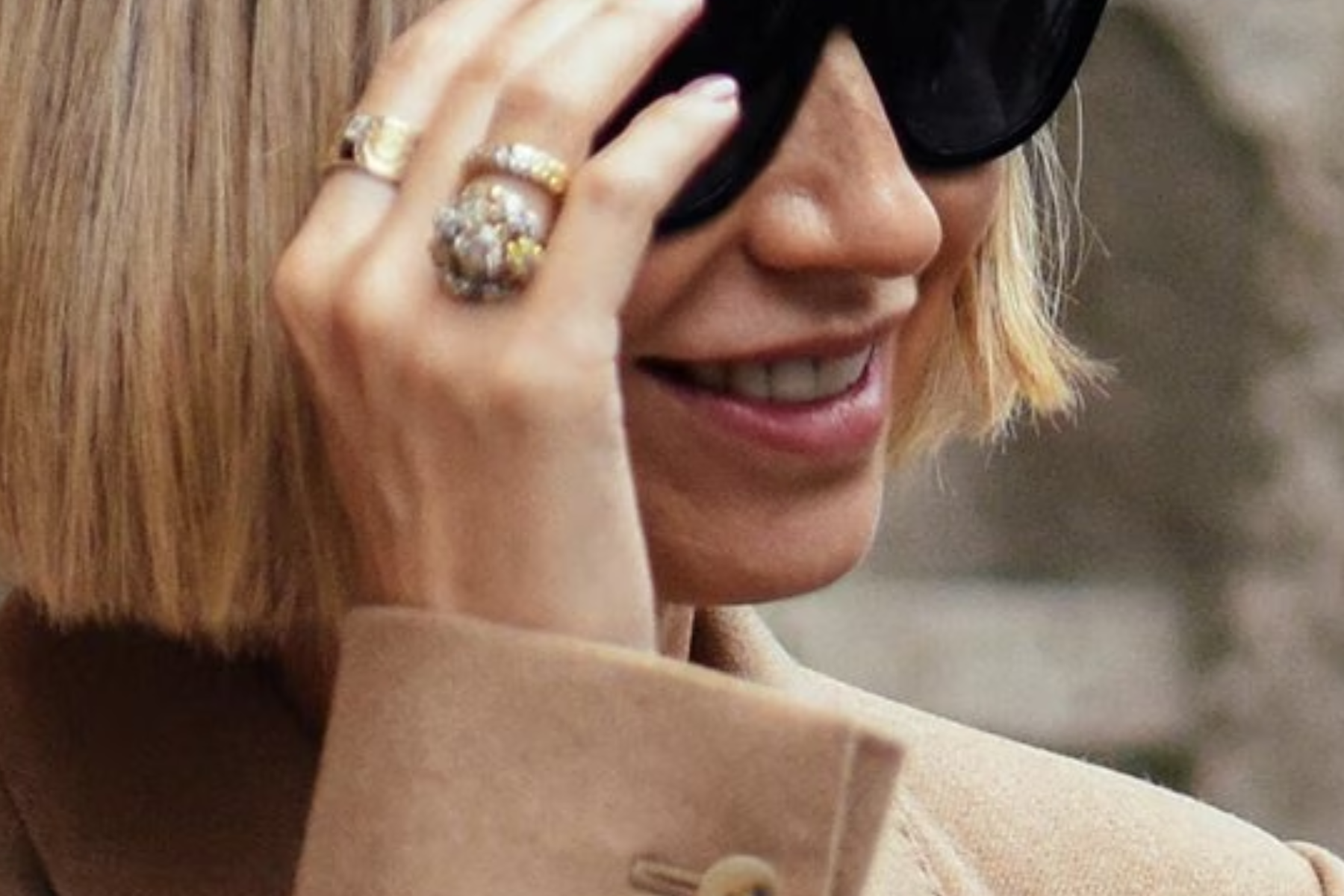 A blonde with short hair wearing cocktail rings