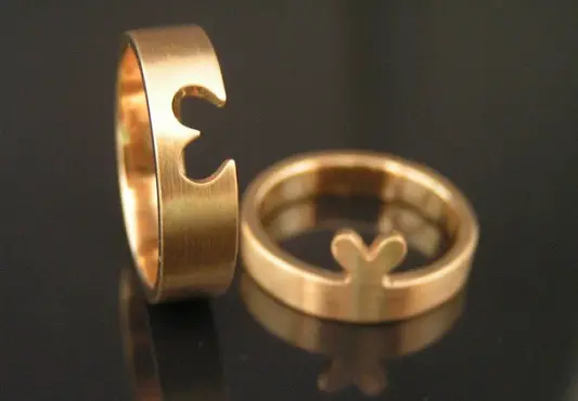A gold ring with a heart for a couple