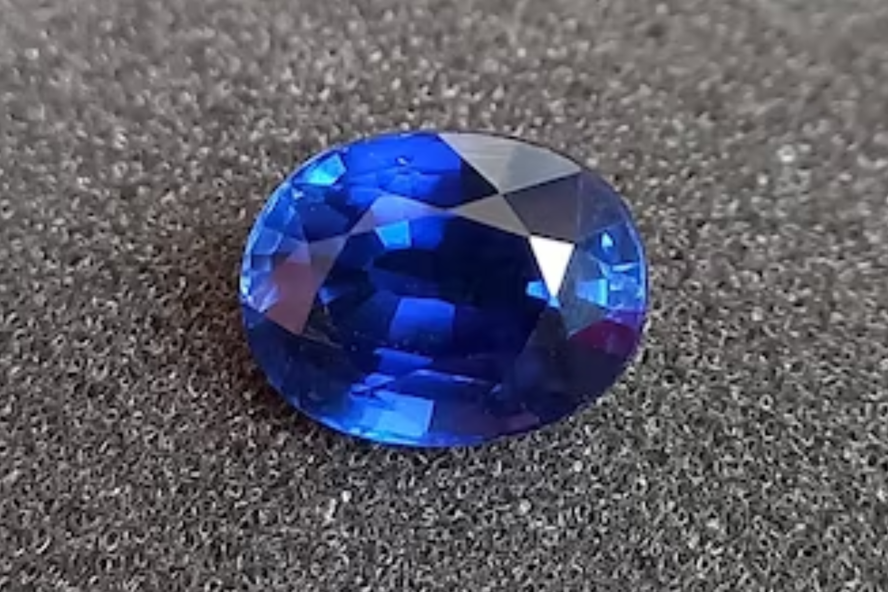 The oval shaped sapphire on the stone ground
