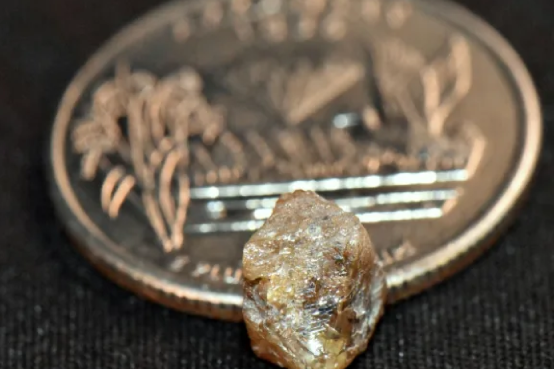 3.29-carat brown diamond with a coin