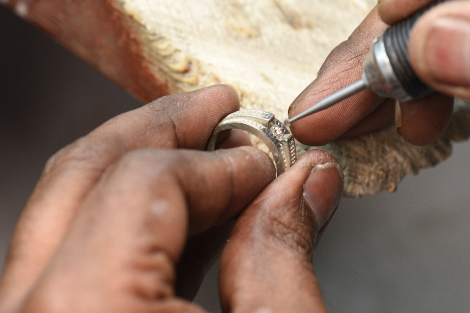 A person's hand at work on a wedding ring