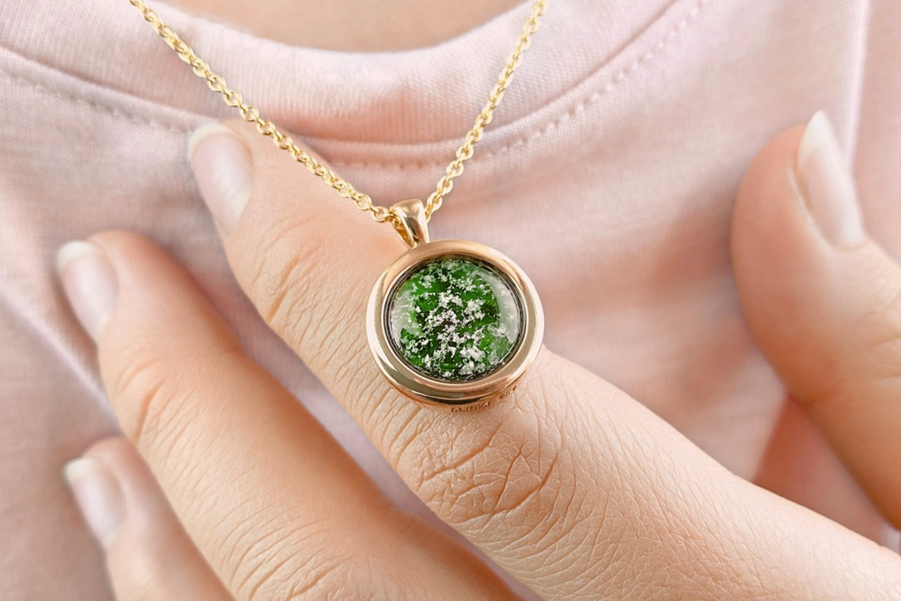 A woman wearing a pendant with a photograph of a tree