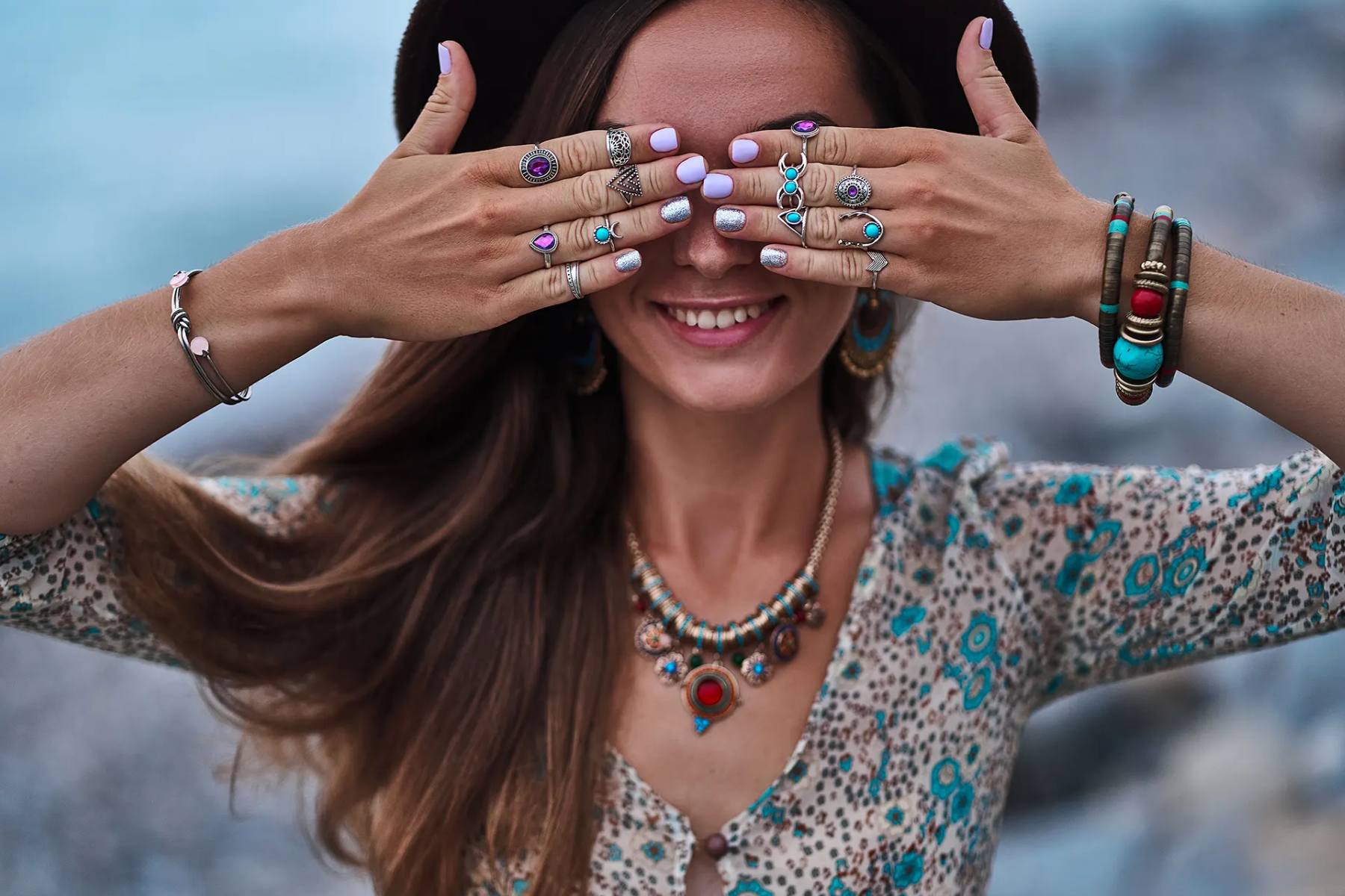 A woman wearing various types of boho jewelry