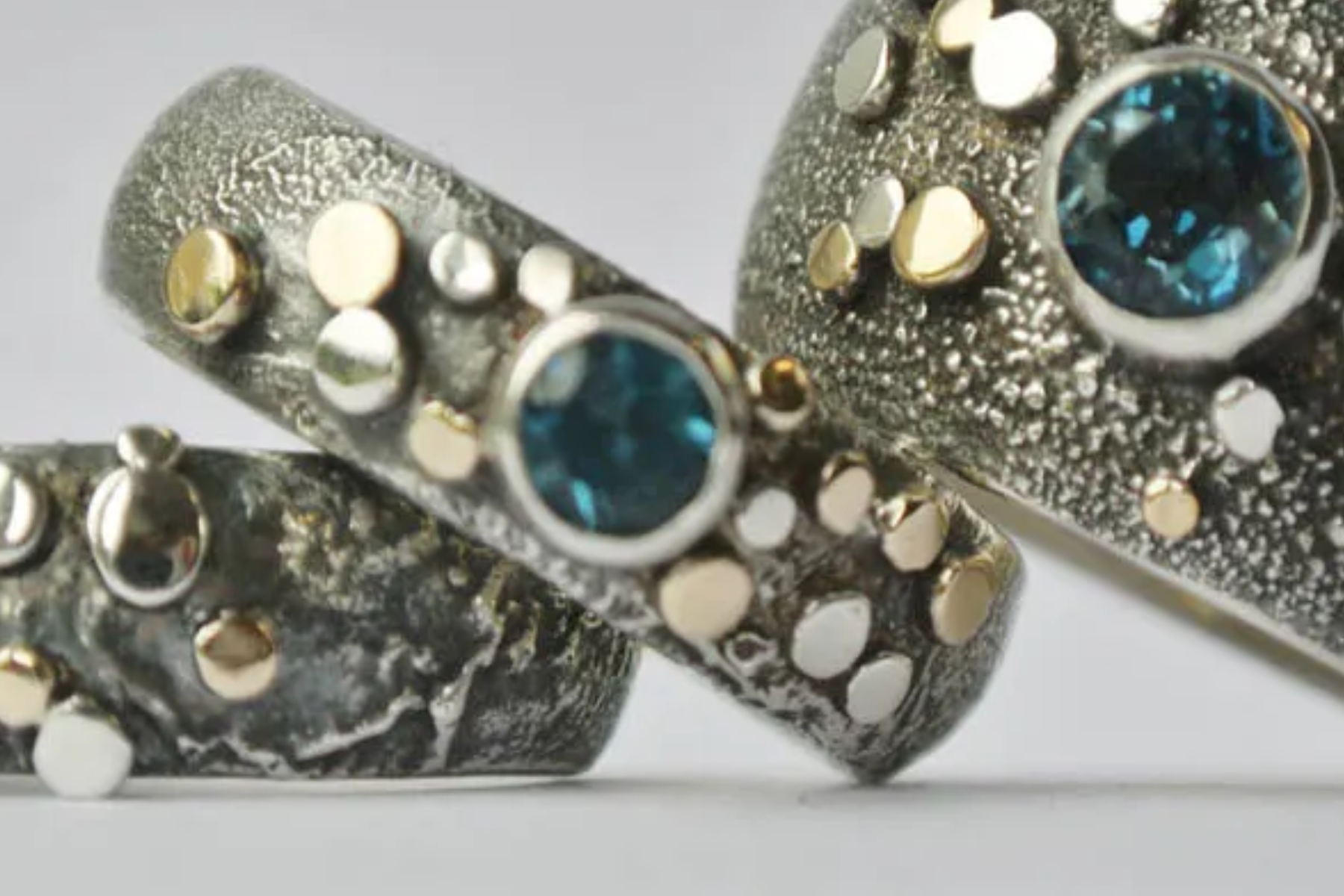Three blue-stoned silver rings