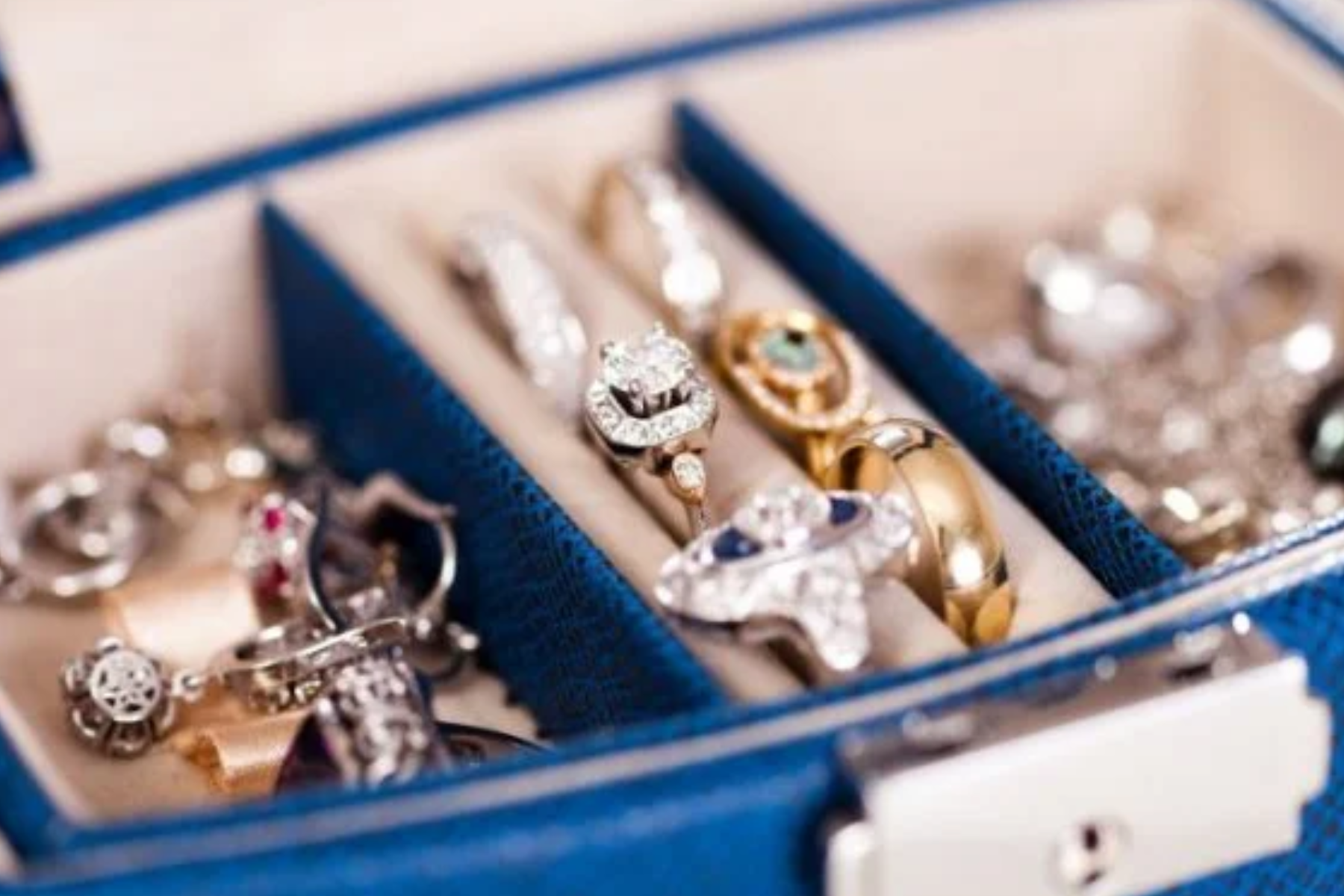 A collection of vintage rings displayed on a secure jewelry box